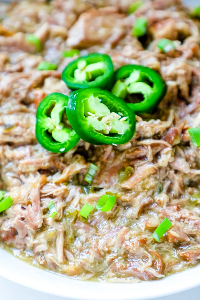 bowl of shredded pork with green chiles and jalapenos on it