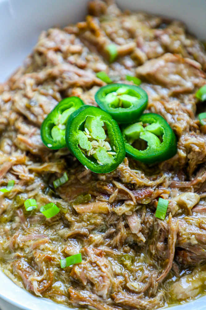 bowl of shredded pork with green chiles and jalapenos on it