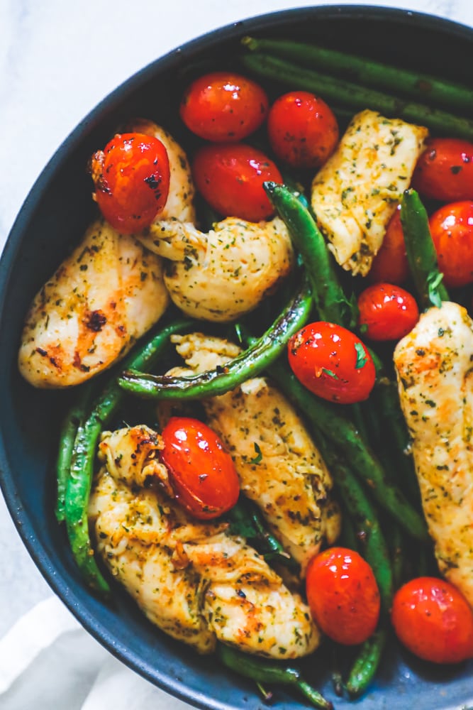 chicken, green beans, and tomatoes in a pan