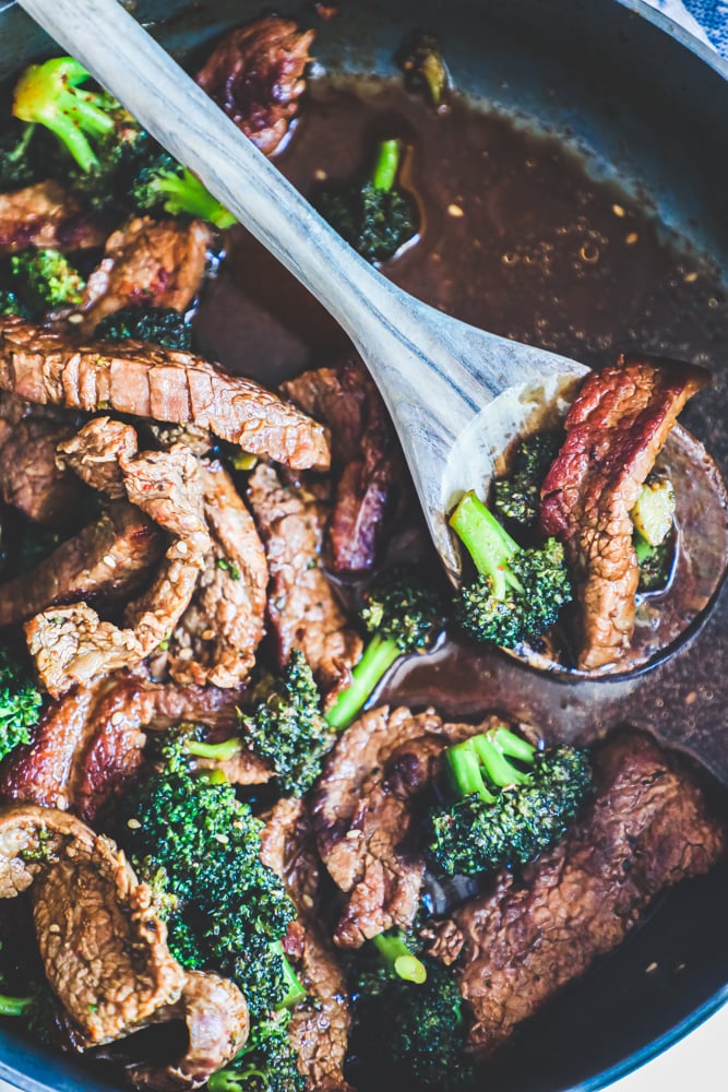 strips of beef, broccoli in a rich sauce. Some meat on a spoon.