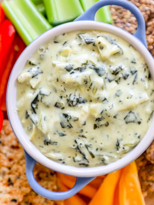 A low carb spinach and artichoke dip served with keto crackers and celery.