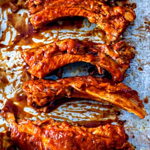 Bbq ribs on a baking sheet using the best instant pot keto ribs recipe.