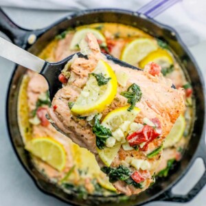 One Pot Creamy Lemon Salmon Florentine Recipe with spinach and lemon in a skillet.