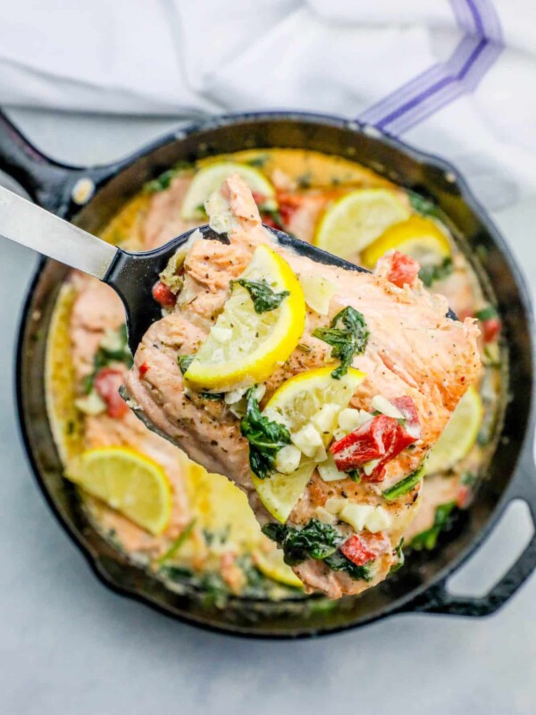 One Pot Creamy Lemon Salmon Florentine Recipe with spinach and lemon in a skillet.