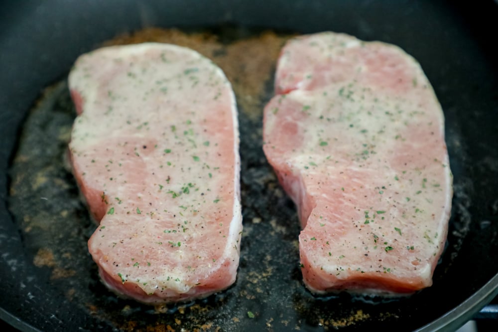 ranch seasoned pork chops cooking in pan 