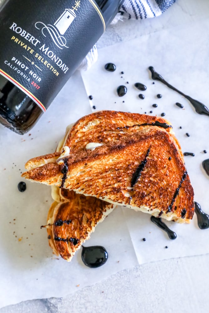 a bottle of wine and a grilled cheese sandwich