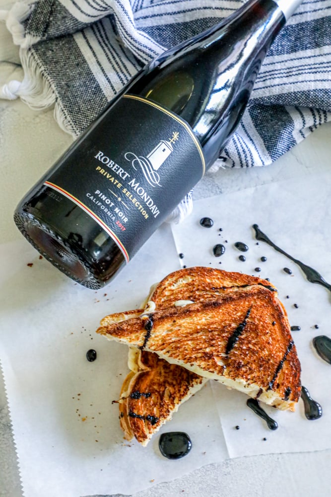 a bottle of wine and a grilled cheese sandwich