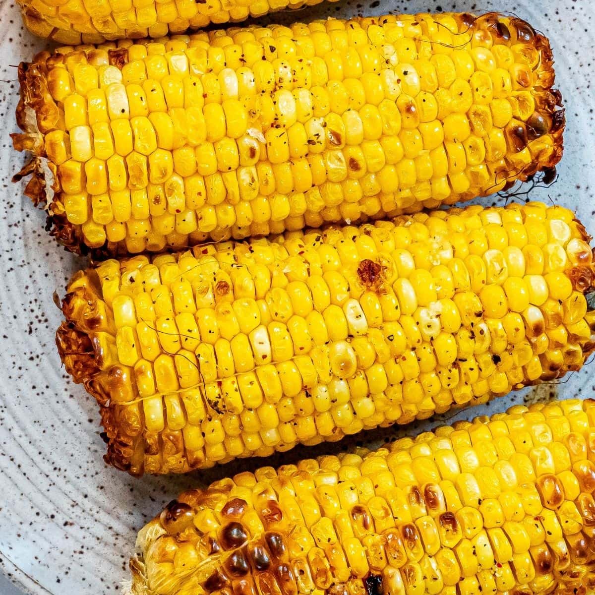 picture of grilled corn on the cob on a plate