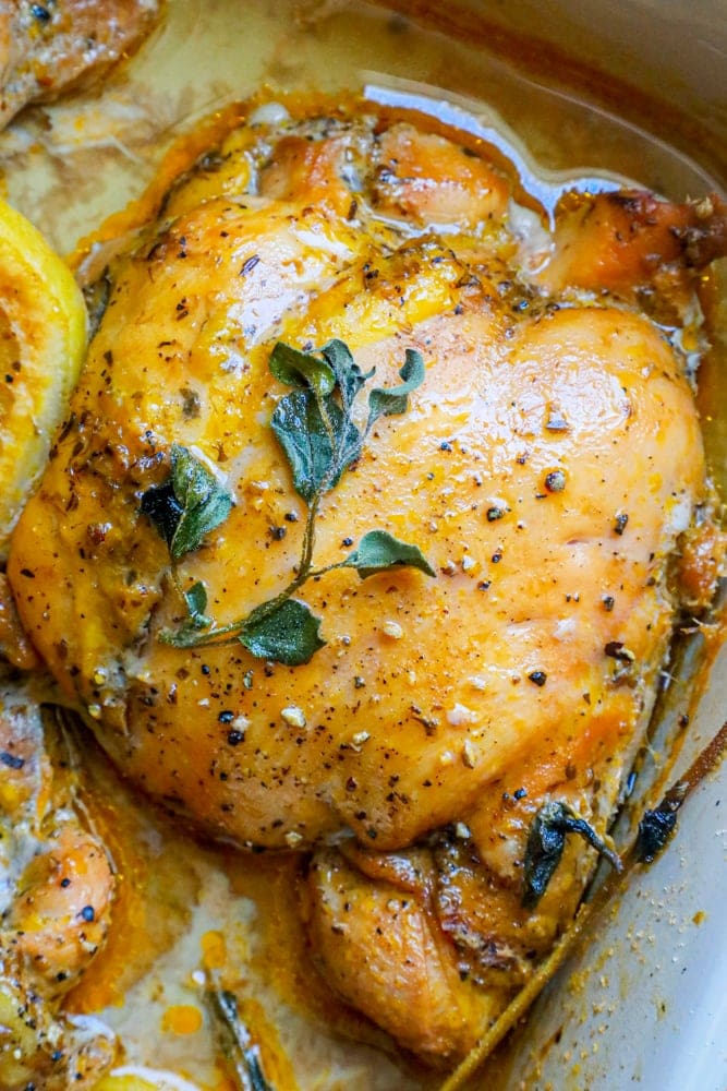 oregano and cracked pepper on top of a chicken thigh