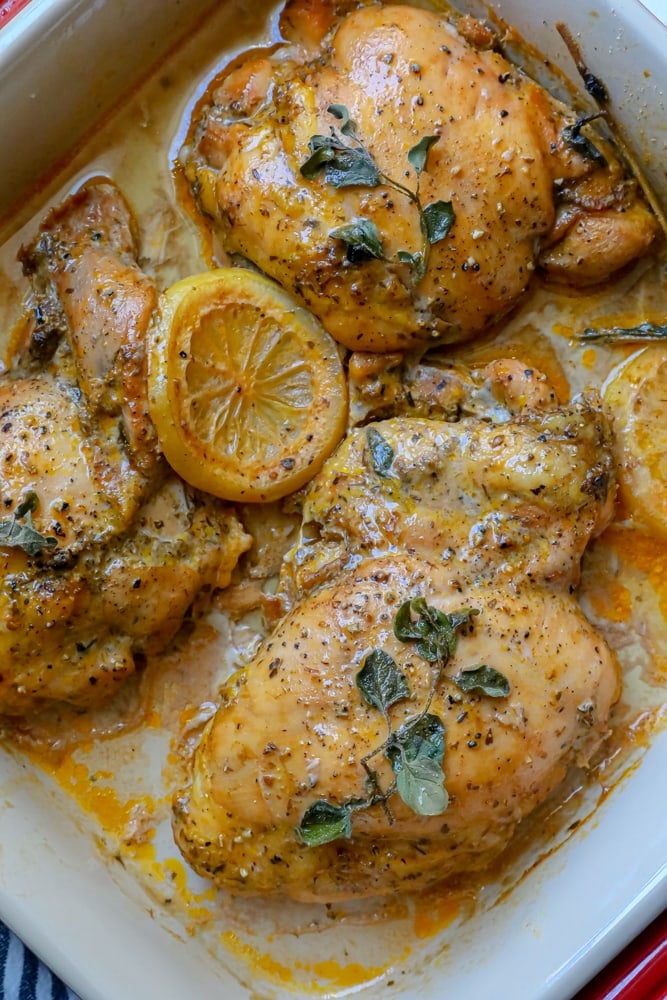 baked chicken thighs in a pan with lemon and oregano 