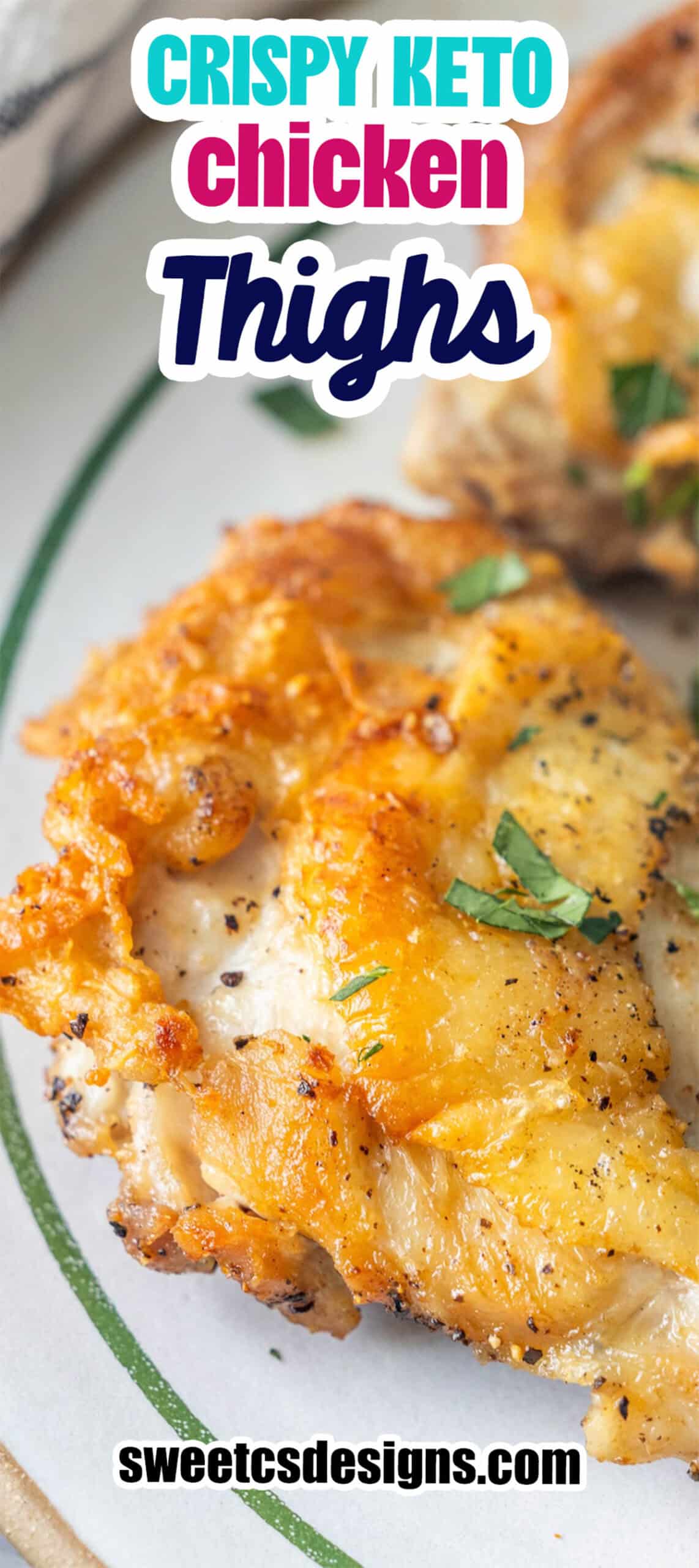Close-up of crispy, golden-brown Keto Fried Chicken Thighs garnished with chopped herbs on a plate, with text overlay promoting a keto chicken recipe from sweetcsdesigns.com.