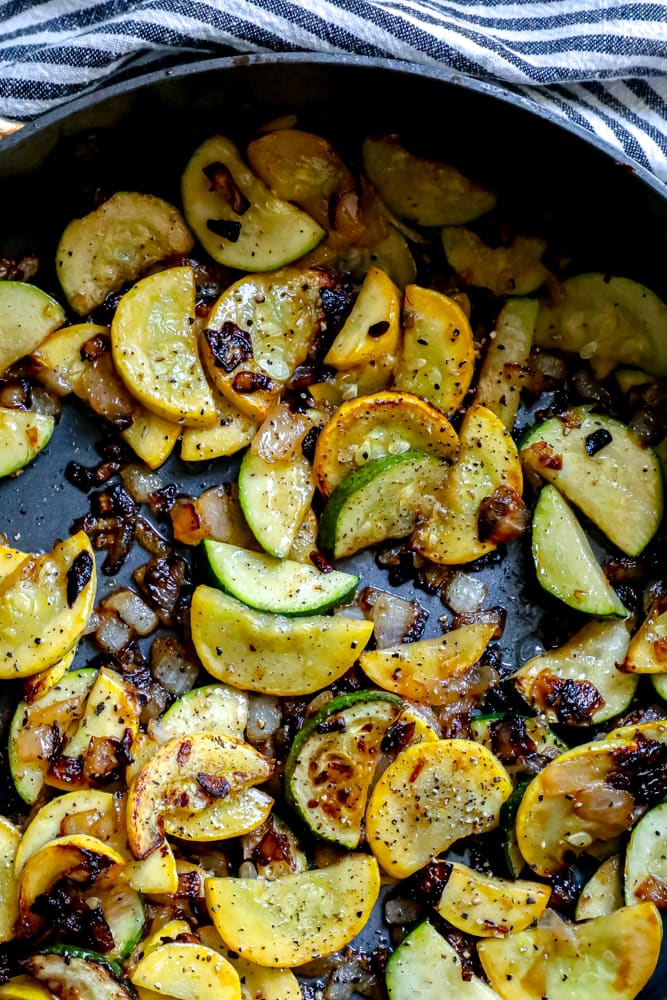 slices of browned zucchini and summer squash in a pan 