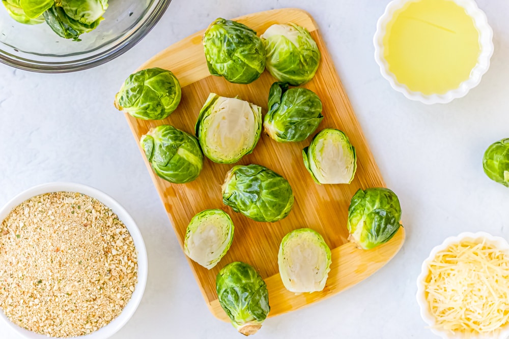 Keto brussels sprouts cooked in an instant pot and air fried to perfection on a cutting board.