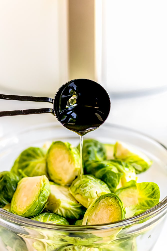 Air fried brussels sprouts being drizzled with olive oil