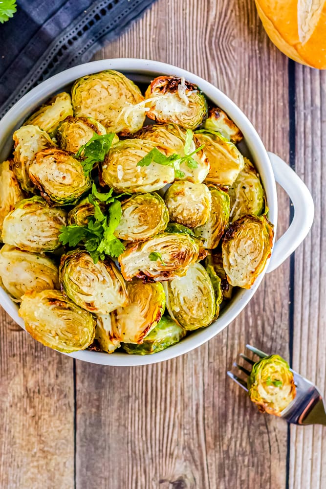 Air fried brussels sprouts in a bowl on a wood table