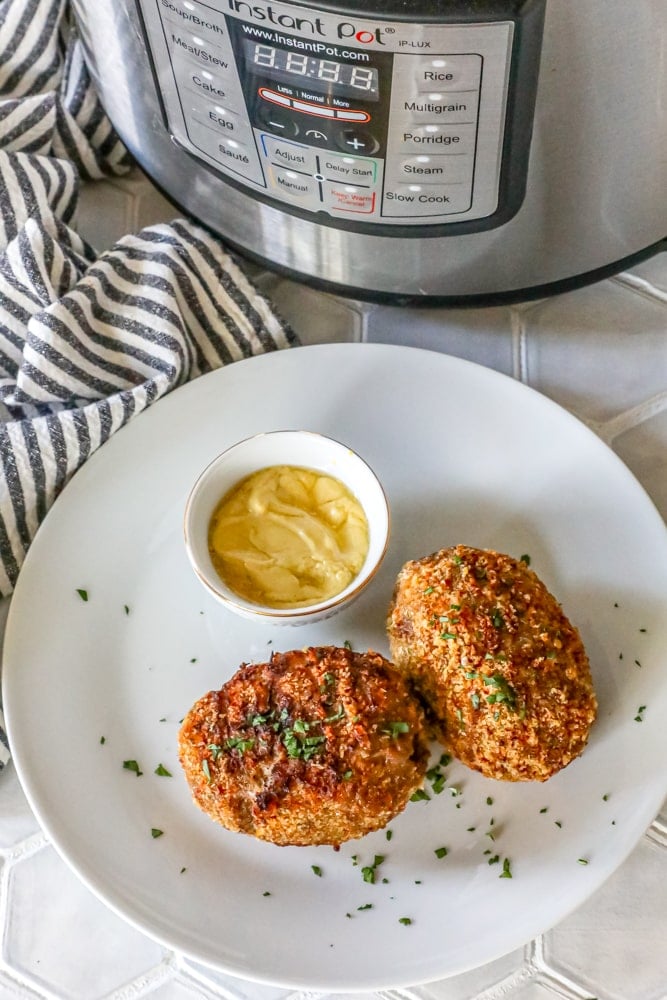 scotch eggs with keto pork rind crust  on a white plate