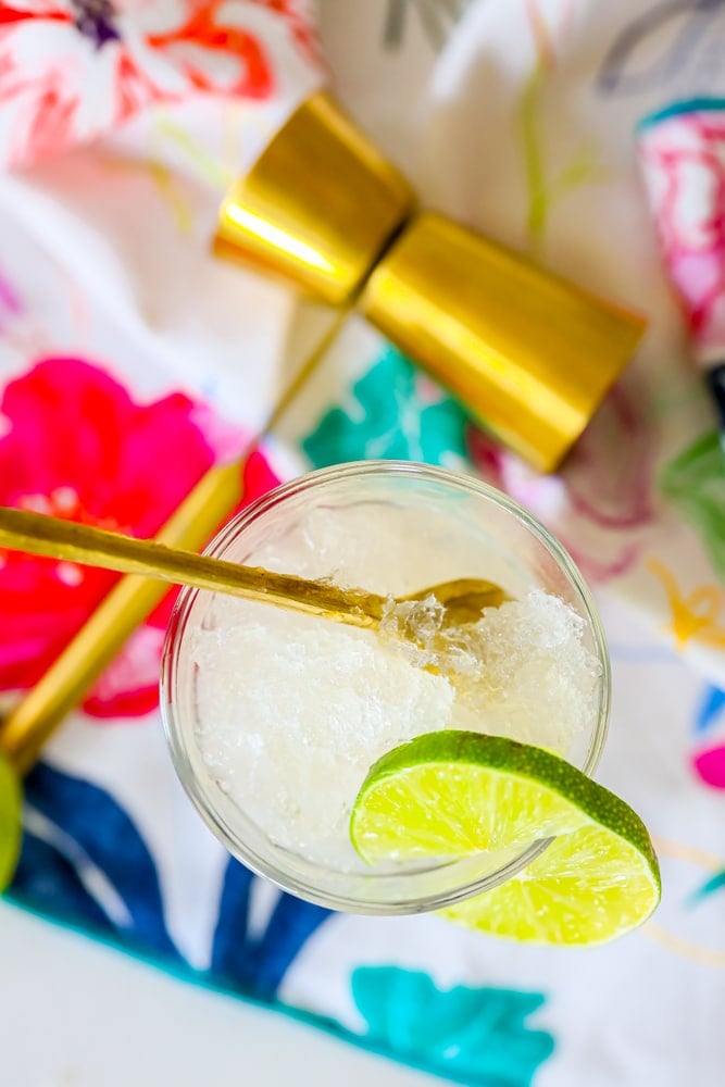 picture of frozen gin and tonic in a glass on a table with a jigger on it