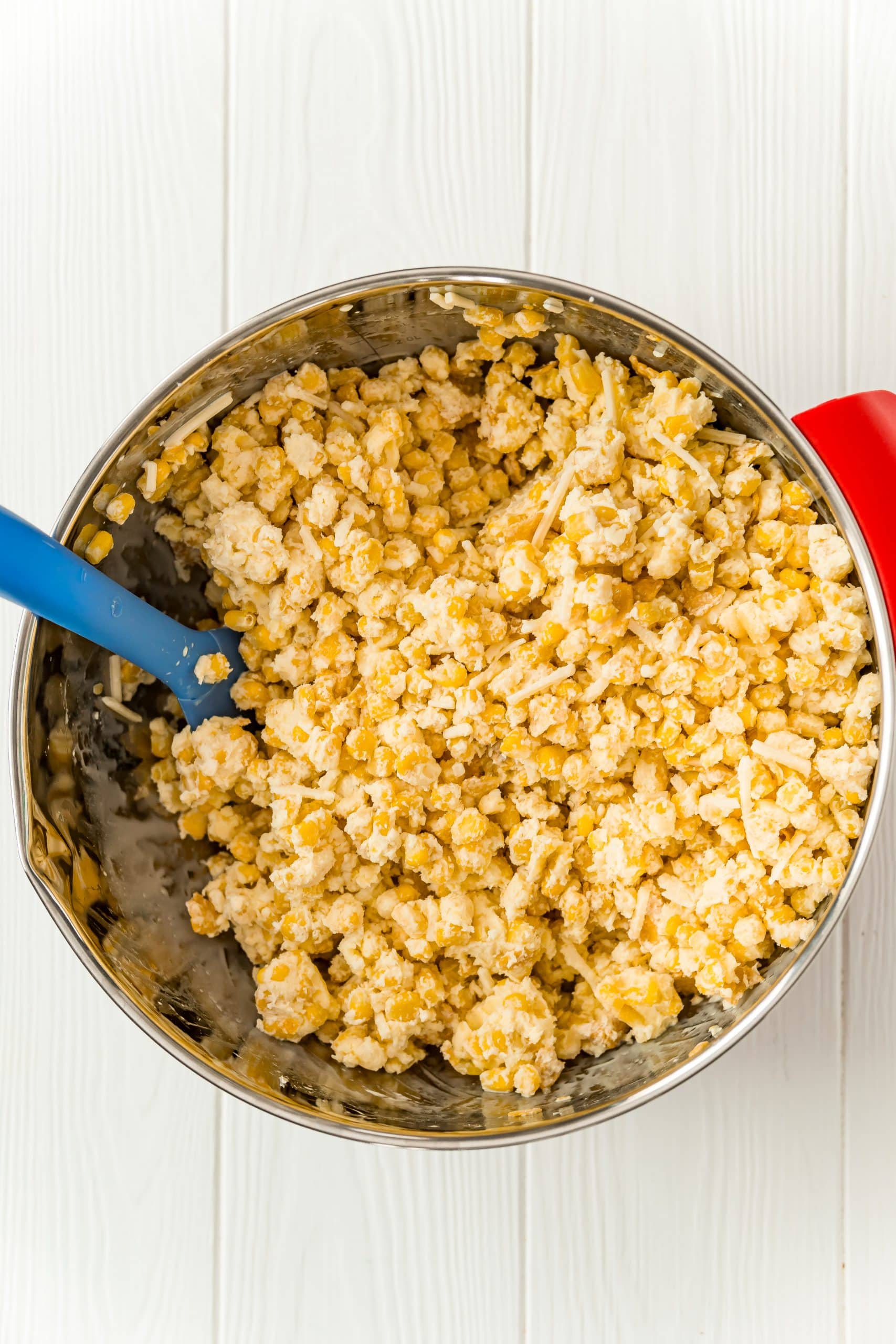 corn and cornflakes mixed with milk and eggs in a bowl