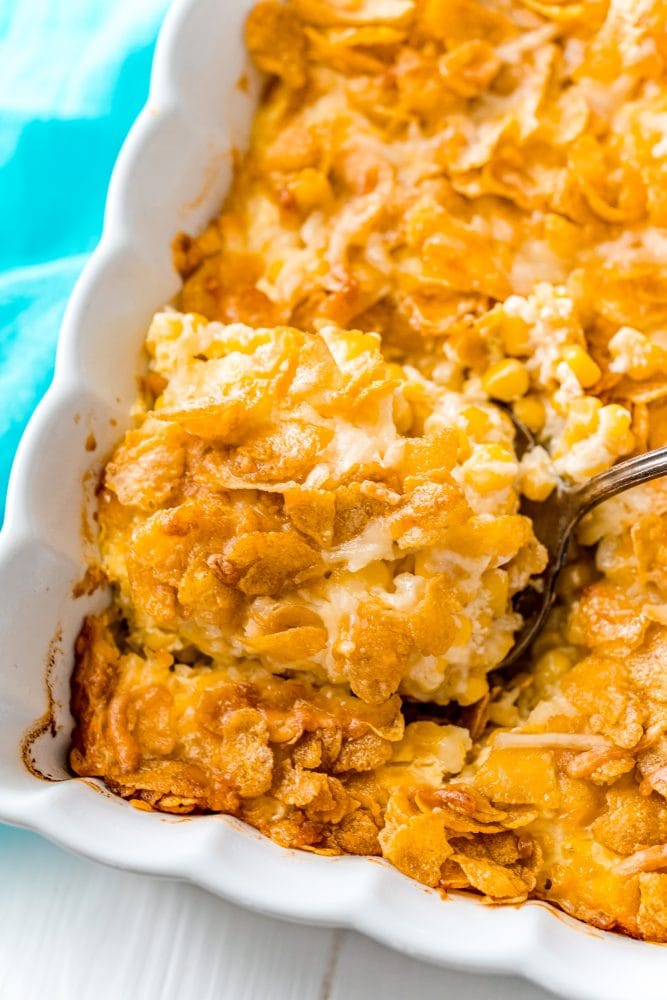 scalloped corn with cornflakes in a white casserole dish