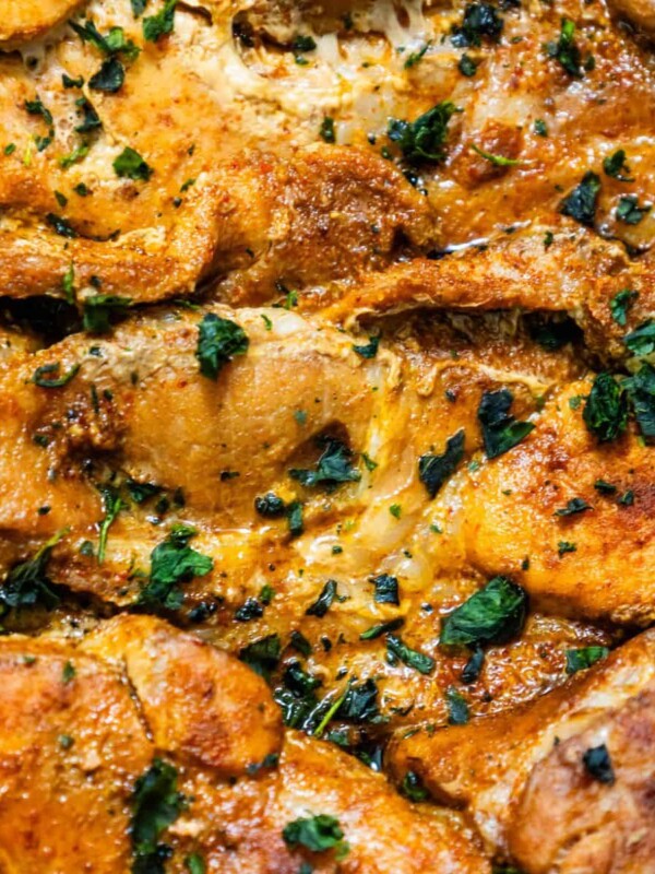 A close up of chicken in a casserole dish, alongside an easy Slow Cooker Pork Steaks Recipe.