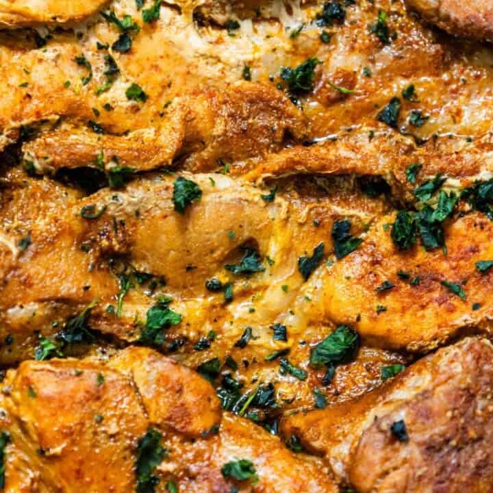 A close up of chicken in a casserole dish, alongside an easy Slow Cooker Pork Steaks Recipe.