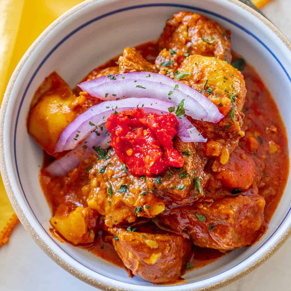 A bowl of rich, keto-friendly Hungarian goulash with tender beef and caramelized onions, ready to be enjoyed.