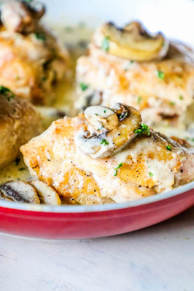 chicken thighs with mushrooms and a creamy garlic sauce in pan picture