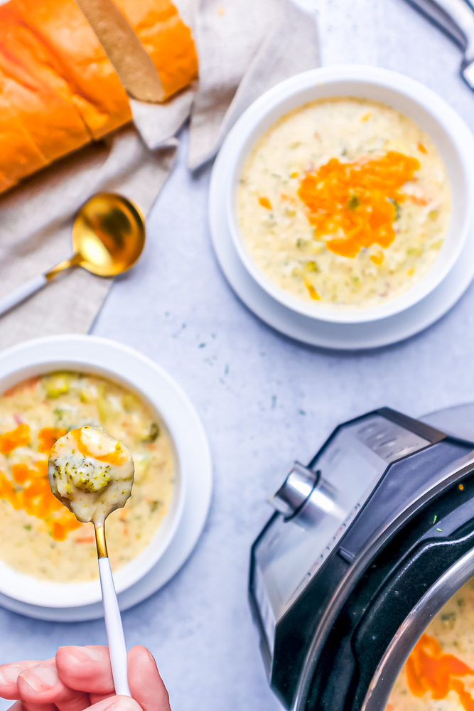 spoon with broccoli cheddar soup next to an instant pot picture