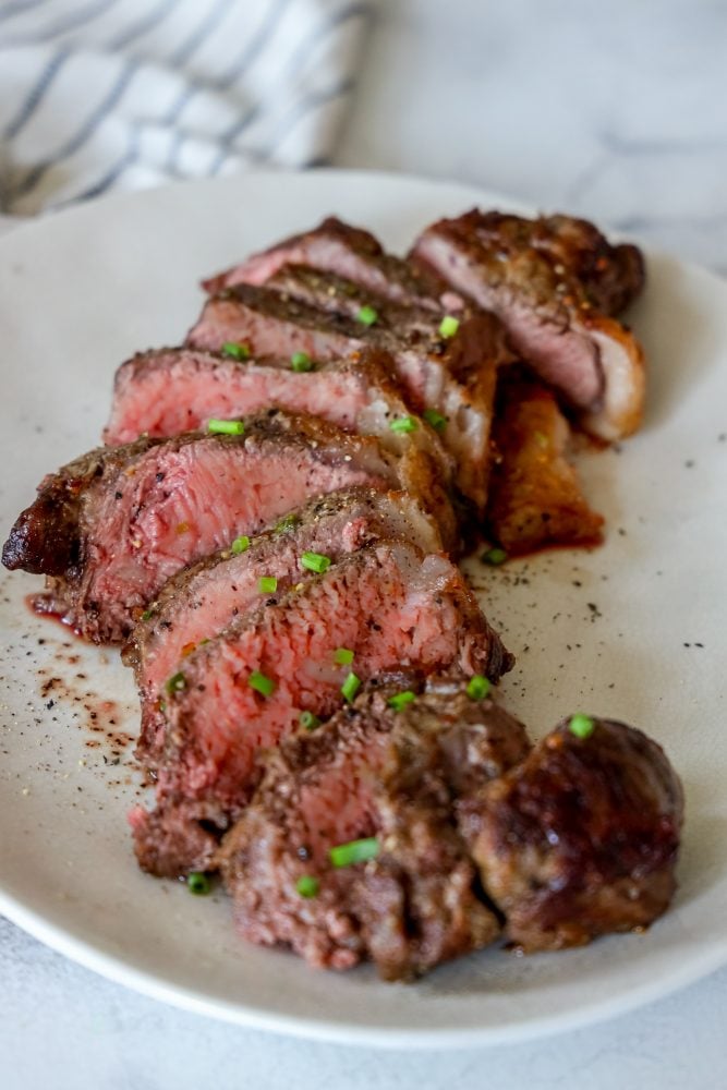 picture of sliced steak on a white plate