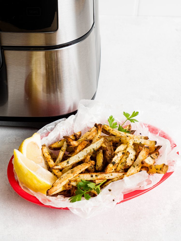 picture of french fries in a basket in front of an air fryer