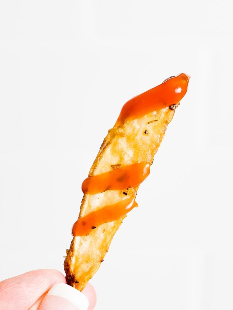 picture of a french fry with ketchup on it 