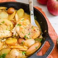A one-pot skillet dinner featuring Dijon chicken thighs, potatoes, and apples.