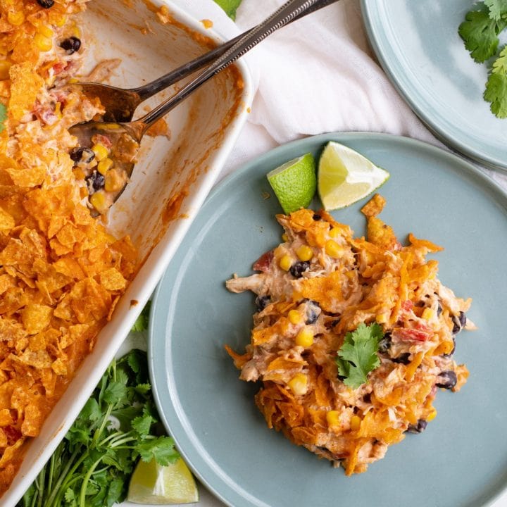 A plate of Easy Doritos Chicken Casserole with limes.