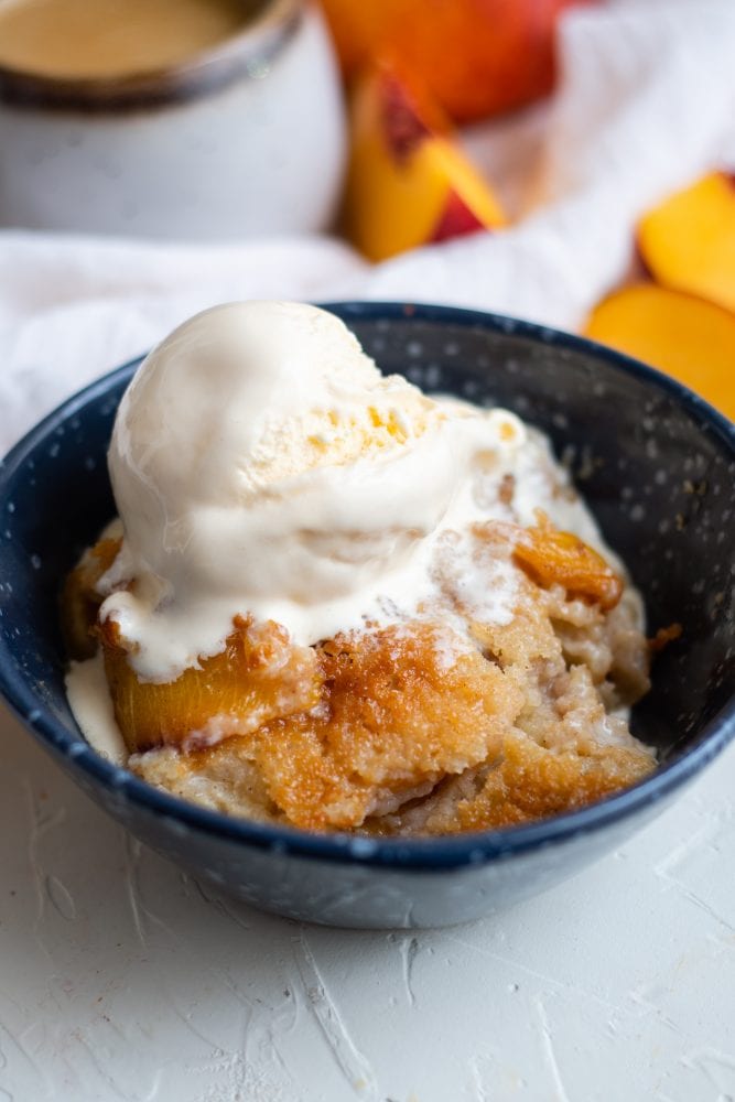 picture of peach cobbler in a bowl with ice cream on top 