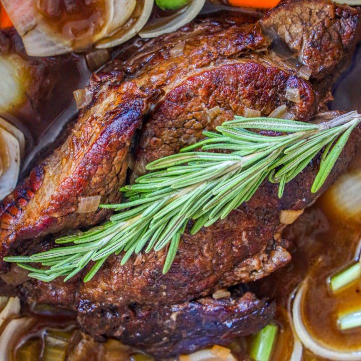 pot roast in a pan with herbs