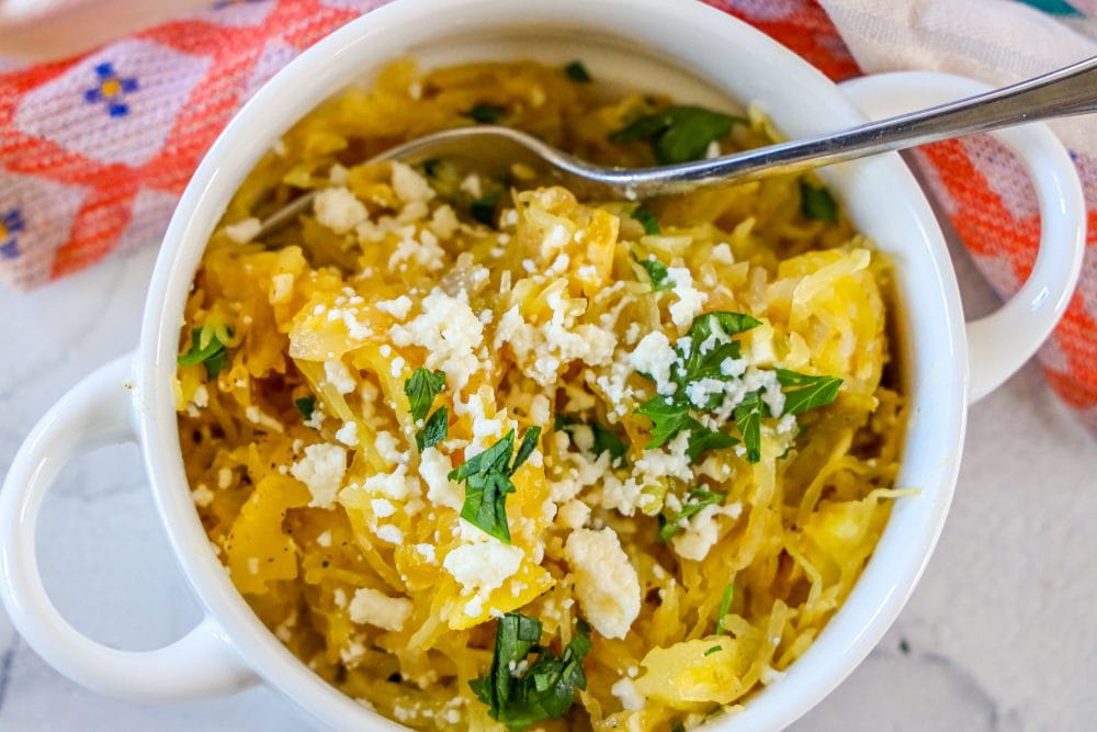 picture of spaghetti squash with green chile sauce and cheese in a white bowl 