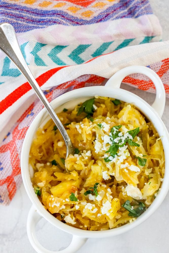 picture of spaghetti squash with green chile sauce and cheese in a white bowl 