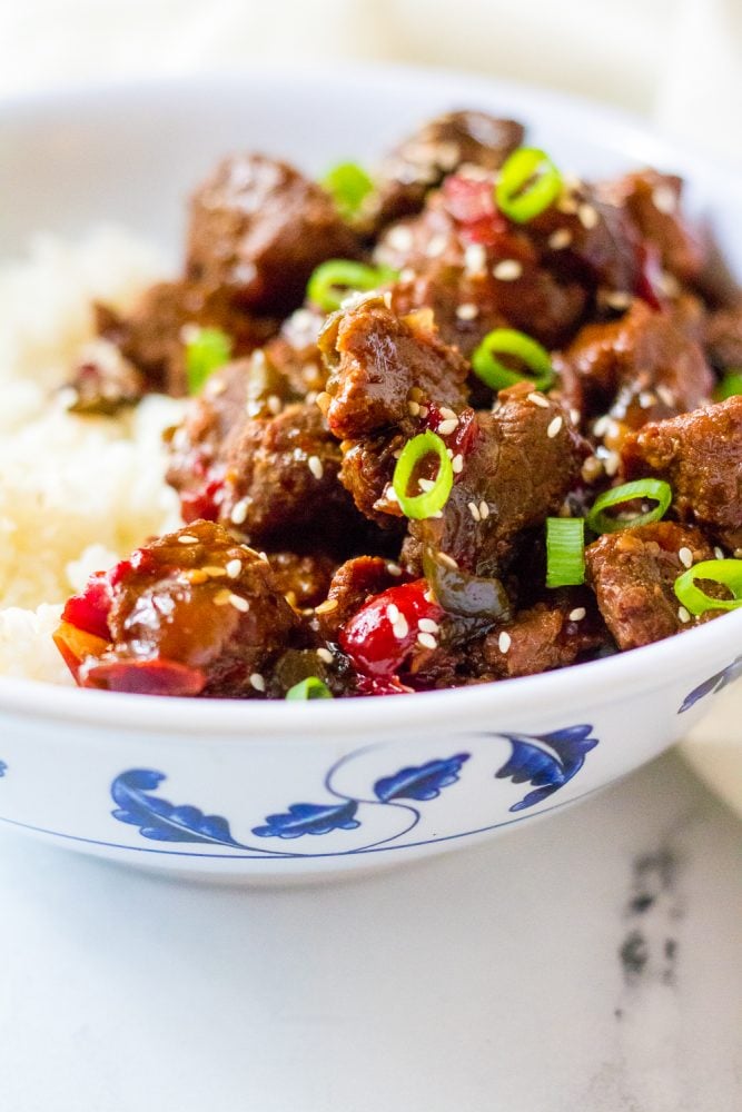 picture of korean beef in a bowl with scallions and rice