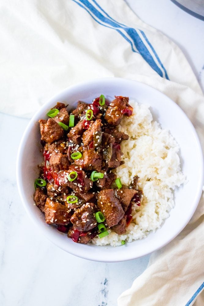 picture of korean beef in a bowl with scallions and rice