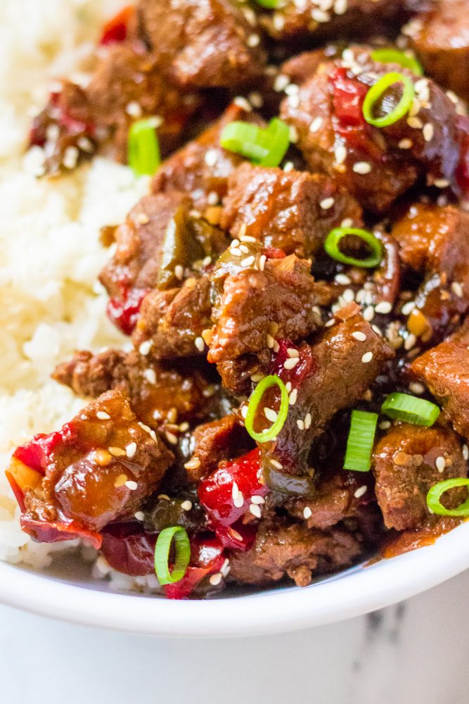 picture of korean beef in a bowl with scallions and rice