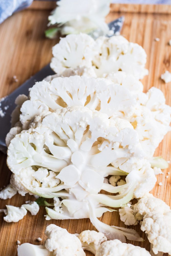 picture of sliced cauliflower steaks on a cutting board