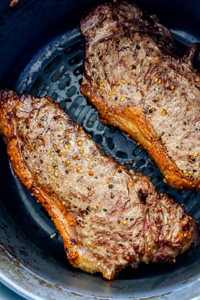 picture of steaks in air fryer basket