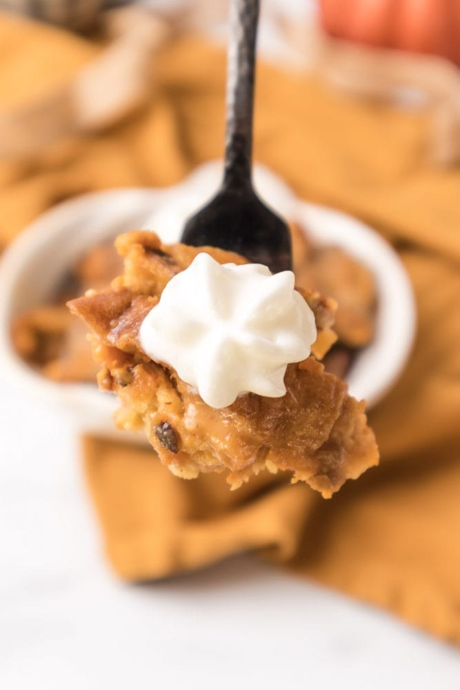 picture of pumpkin bread pudding with whipped cream on a fork 