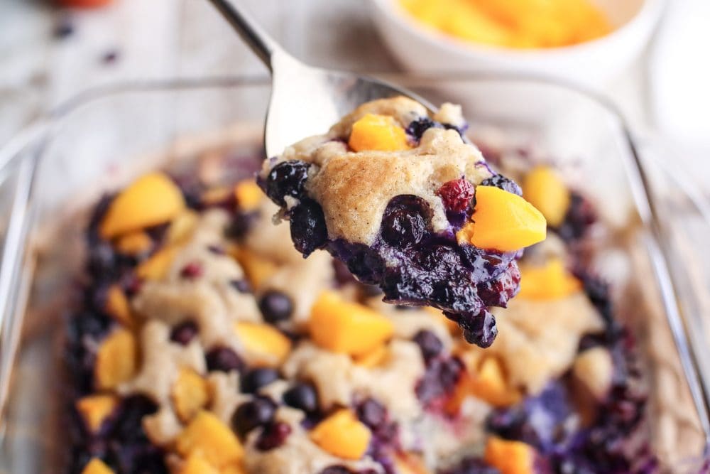 blueberry peach baked cobbler with baked topping on it