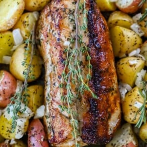 picture of roasted pork loin and potatoes in a sheet pan