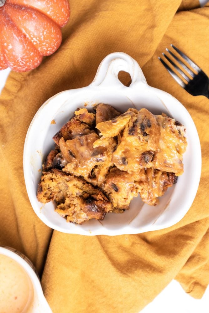 picture of pumpkin bread pudding with whipped cream with a fork 