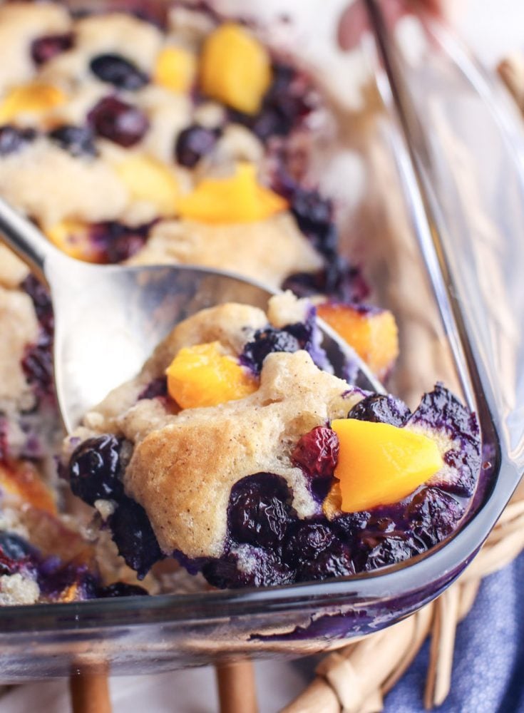 blueberry peach baked cobbler with baked topping on it
