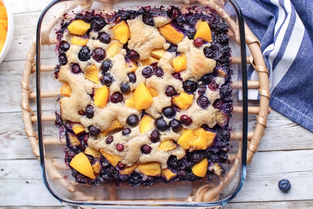 blueberry peach baked cobbler with baked topping on it