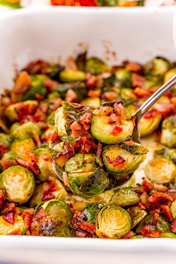 picture of a brussels sprout with bacon on a fork 