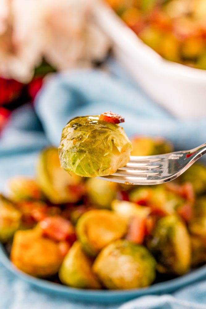 picture of a brussels sprout with bacon on a fork 